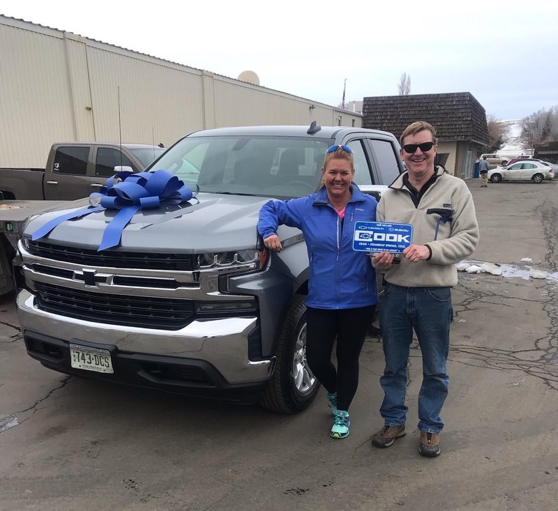 Happy customers standing in front of their new truck at Cook Chevrolet in Craig, CO